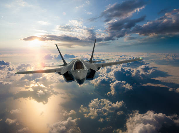 F-35 Fighter Jet flying over ocean at sunset F-35 Fighter Jet flying over ocean at sunset fighter plane stock pictures, royalty-free photos & images
