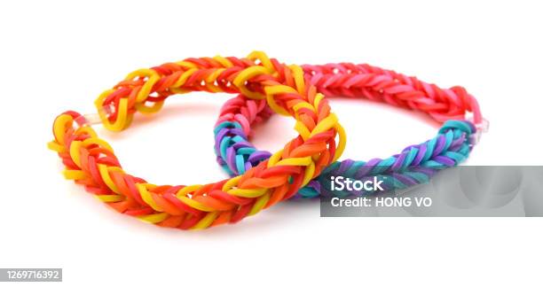 colorful Rainbow loom bracelet rubber bands fashion on old wood background.  - Stock Image - Everypixel