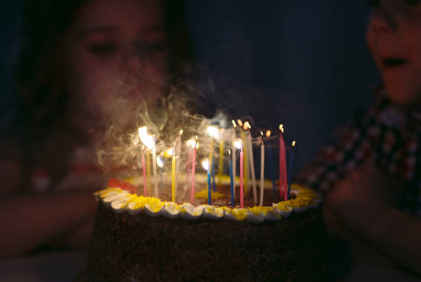 istock Birthday. A Kids blows out candles on the stoke 1269717320
