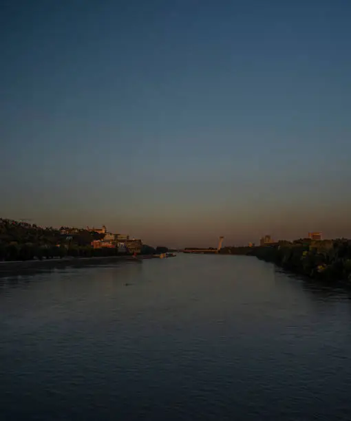 Photo of Bratislava capital in summer evening with color sunset and river Donau