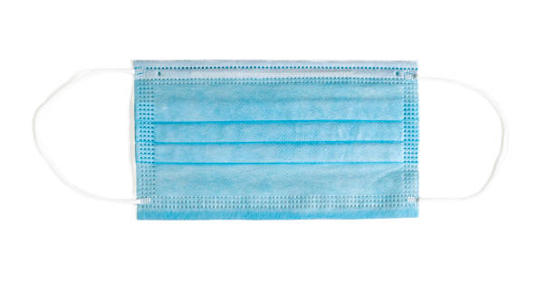 istock Blue surgical mask isolated on white. 1269717390