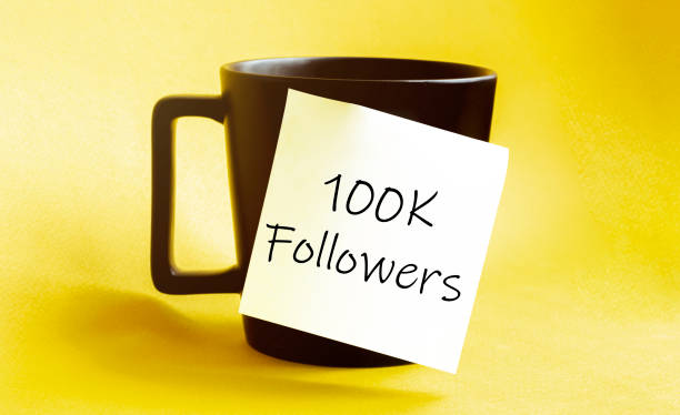 istock white paper with text 100K Followers on the black cup 1269717577