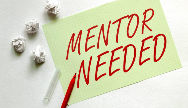 istock yellow paper with text Mentor Needed on the white with red marker 1269717581