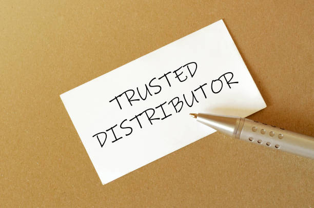 istock pen, white paper with text Trusted Distributor on the brown background 1269717583