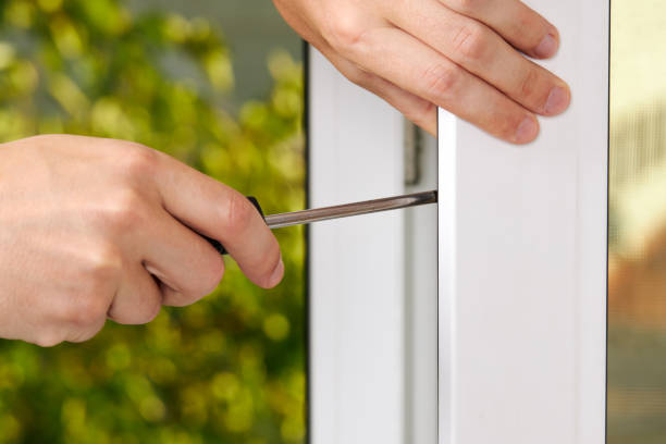 istock handyman adjusting white pvc plastic window indoors. worker using screwdriver to repair upvc window. homework maintenance 1269717639