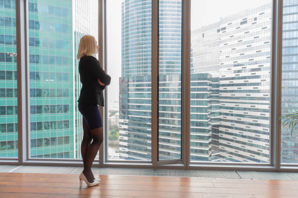 istock Business woman stands in office 1269718461