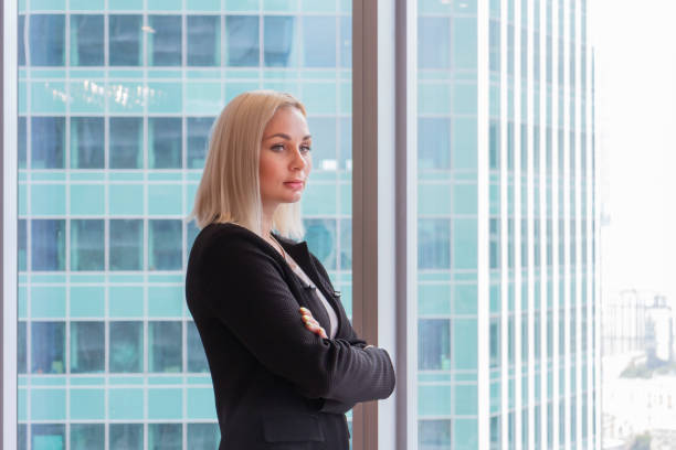 istock Business woman stands in office 1269718520