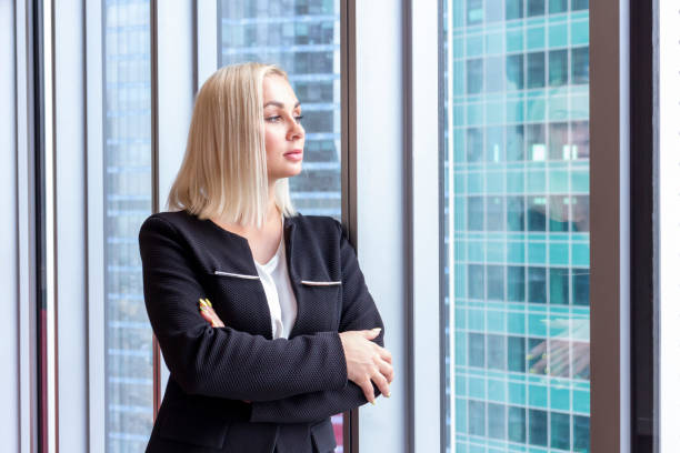 istock Business woman stands in office 1269718555