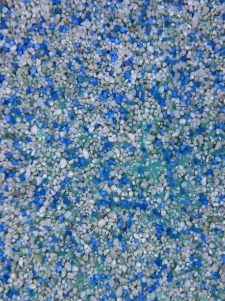 istock Background with blue and white pebbles on turquoise.   Under water. 1269720059