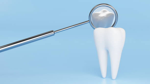 istock White tooth with reflection in metal dental mirror. Dentist background design concept. 3D rendering image. 1269722534