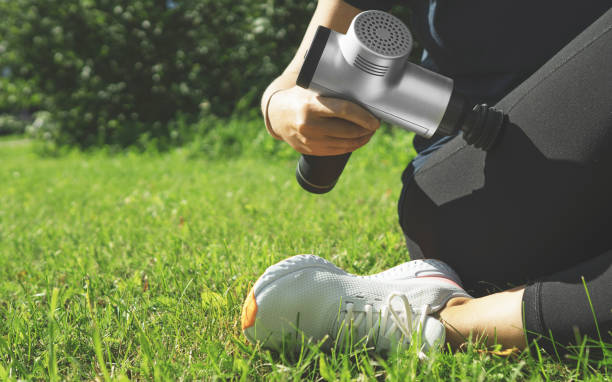 istock Woman massaging leg with massage percussion device after workout. 1269723542