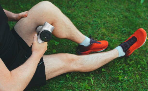 istock Man massaging leg with massage percussion device after workout. 1269723554