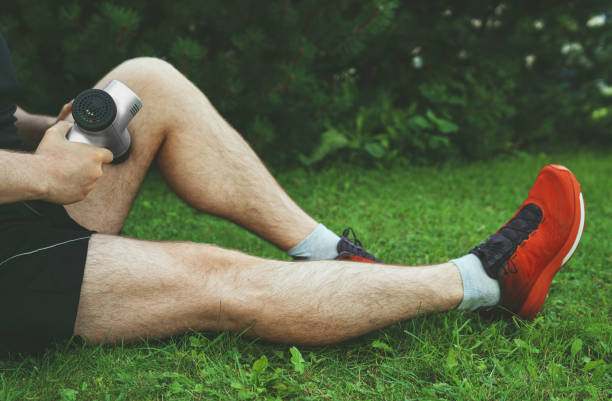 istock Man massaging leg with massage percussion device after workout. 1269723561