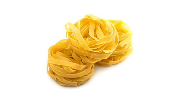 istock Uncooked fettuccine nest pasta on white background 1269724853