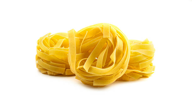 istock Uncooked fettuccine nest pasta on white background 1269724967