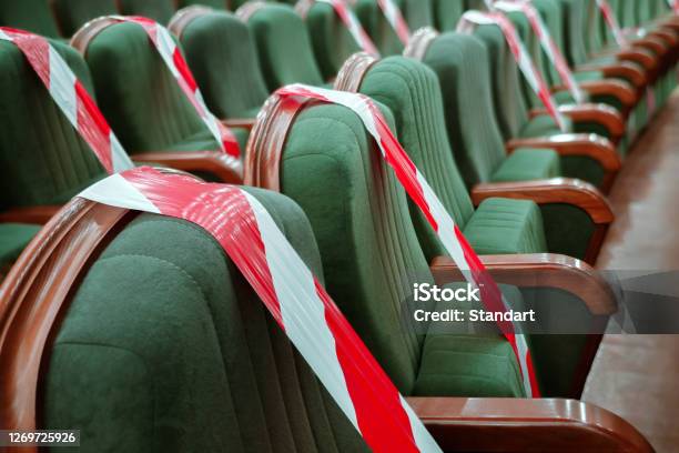 Background Of Empty Seats In The Cinema Theater Auditorium With A Warning Label Presentation Of A Conference Opera Theatrical Performance Work During Coronavirus Adhering To Social Distancing Stock Photo - Download Image Now