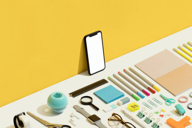 Stationary flat lay on yellow and white background. Office, school supplies with white blank copy space screen smart phone on yellow and white background.