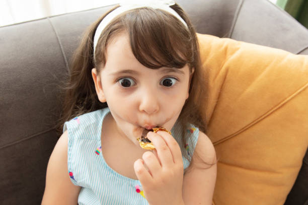 istock Little girl eating chocolate 1269728156