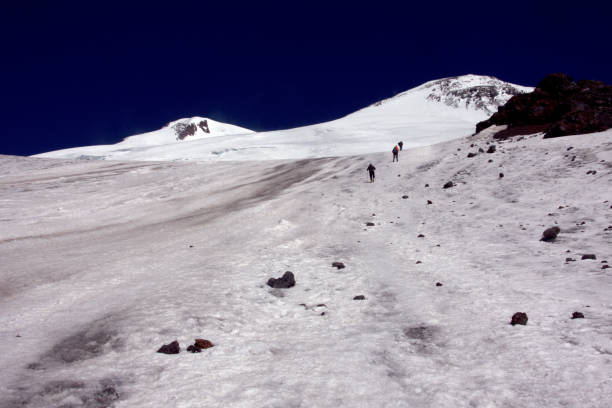 istock Climbing Elbrus. Snow-capped mountain peaks and climbers. 1269730891
