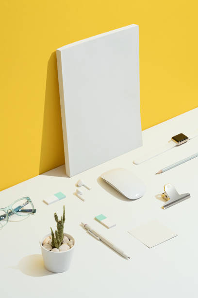 Personal accessories, office supply flat lay on yellow and white background. Personal accessories, office supply flat lay on yellow and white background. Personal accessories and stationary items knolling with blank white cover magazine. square business card mockup stock pictures, royalty-free photos & images