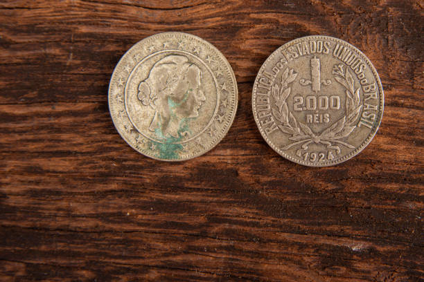 istock Old coins placed on a rustic wooden platform, top view. 1269731087