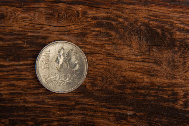 istock Old coins placed on a rustic wooden platform, top view. 1269731097
