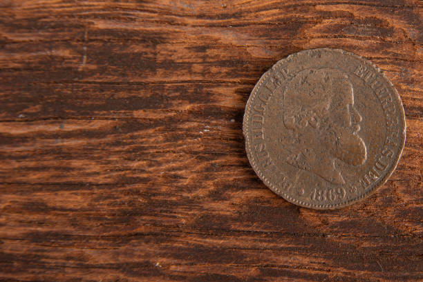 istock Old coins placed on a rustic wooden platform, top view. 1269731127