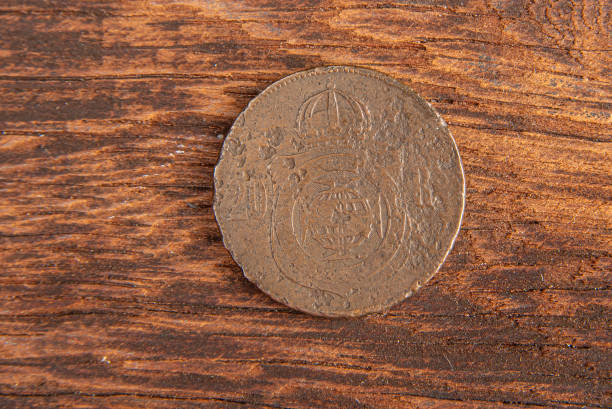 istock Old coins placed on a rustic wooden platform, top view. 1269731147