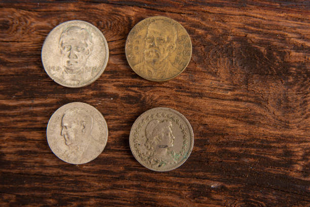 istock Old coins placed on a rustic wooden platform, top view. 1269731171