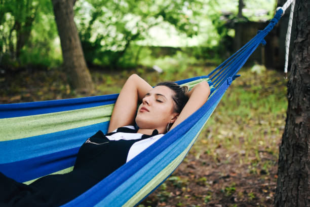 istock Beautiful woman enjoying in hammock 1269732231