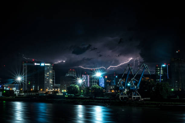 istock Dramatic night city skyline with a lightning strike 1269733824