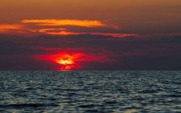 istock Bright red sunset over the sea surface. 1269734523
