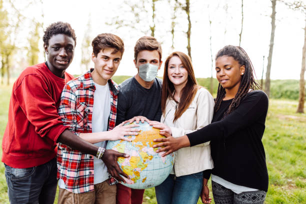 istock multiracial friends with globe during the covid 1269734719