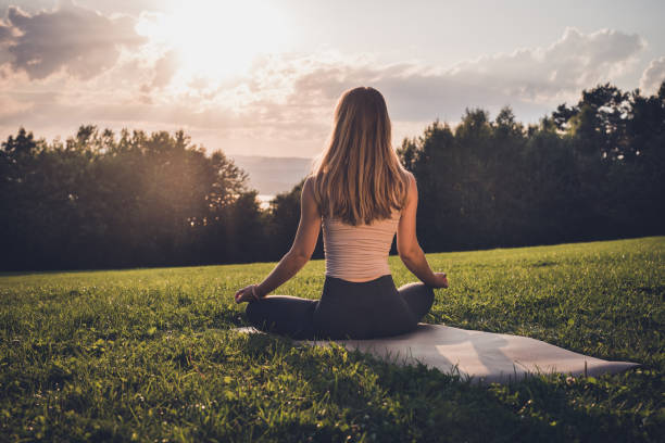 istock Meditation in nature at sunset. 1269735705