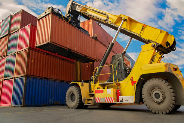 istock Crane lifting up container in a port. 1269735855