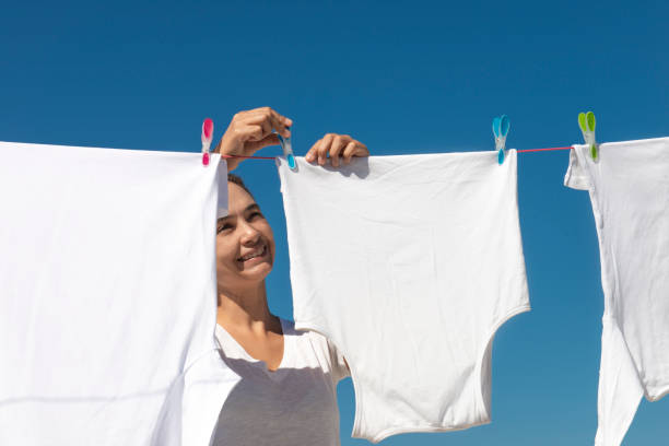 istock Woman Hanging White Clothes 1269736766