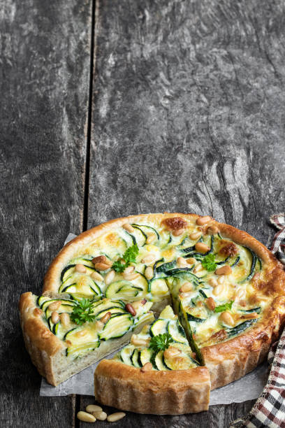 istock Vegetarian pie with zucchini and pine nuts on rustic wooden table 1269738994