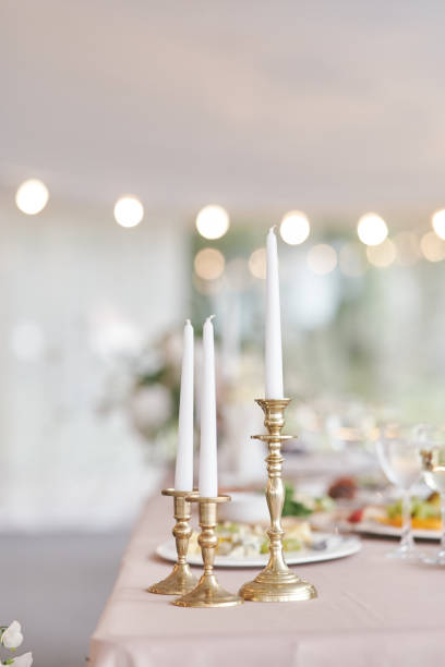 istock White candles in candlesticks at a wedding celebration 1269740570