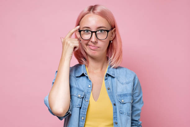 istock caucasian woman with pink dyed hair thinking trying to solve a problem. 1269743483