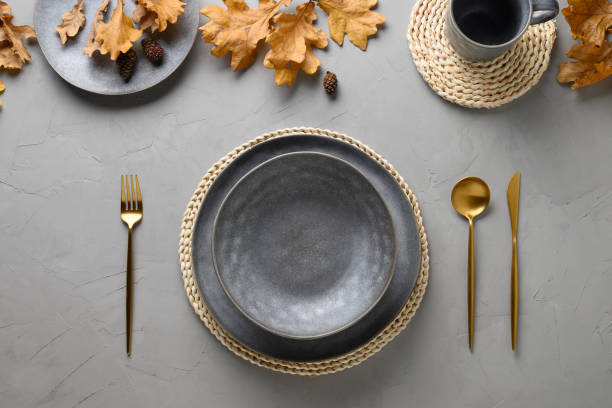 istock Autumn table setting with seasonal harvest and gold decor on grey table. Flat lay, top view. Space for text. 1269744501