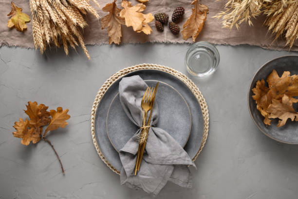 istock Autumn table setting with seasonal harvest and gold decor on grey table . Flat lay, top view. 1269744503