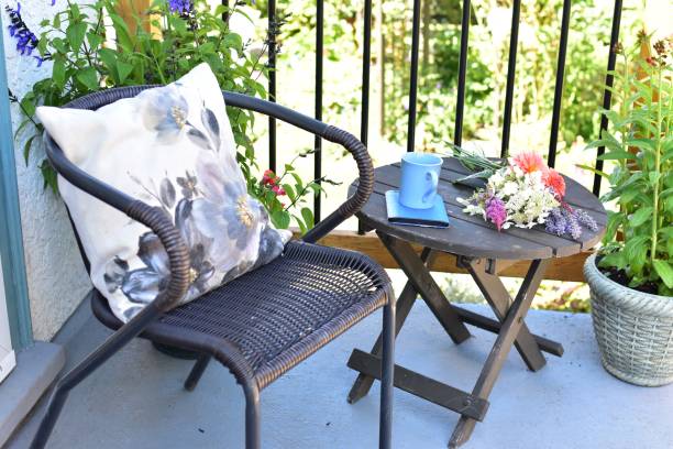 Outdoor patio seating for relaxing or working from home on sheltered small space deck during summer afternoon