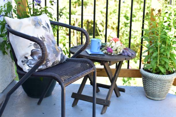 istock Outdoor patio seating for relaxing or working from home on sheltered small space deck during summer afternoon 1269745673