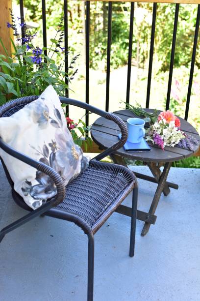 Outdoor patio seating for relaxing or working from home on sheltered small space deck during summer afternoon