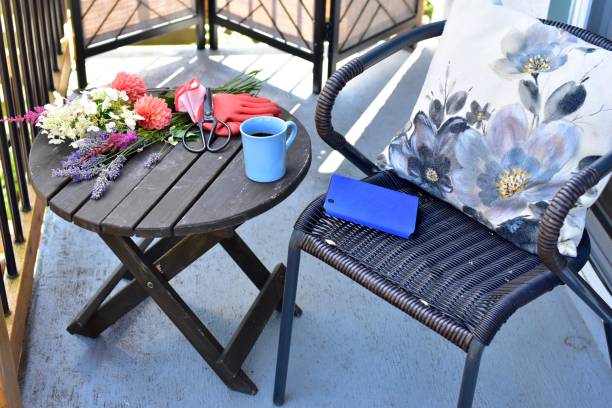 Outdoor patio seating for relaxing or working from home on sheltered small space deck during summer afternoon