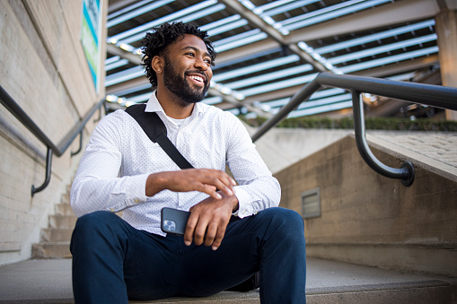 A portrait of a confident smiling young black man