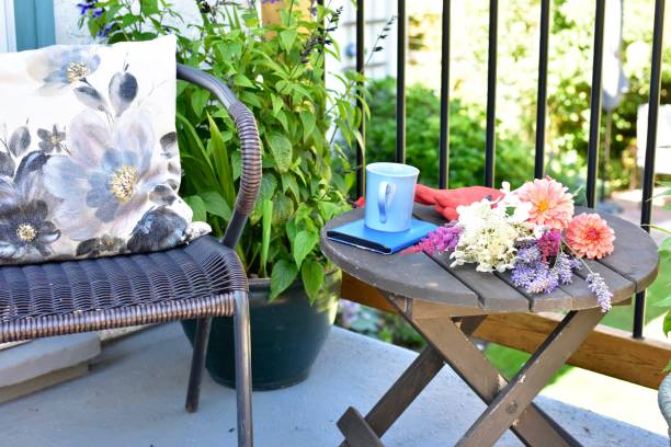 Outdoor patio seating for relaxing or working from home on sheltered small space deck during summer afternoon