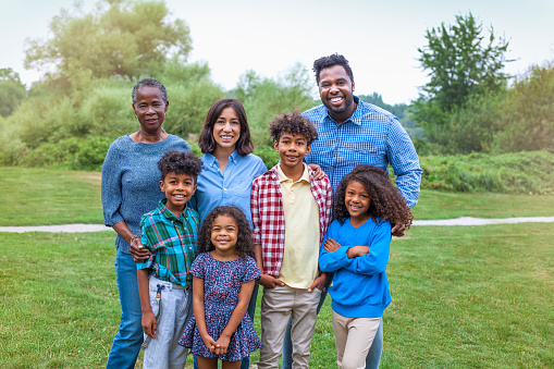 Portrait of multi generation mixed race multicultural family at public park