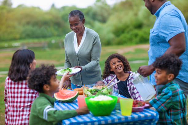 istock Multi generation family enjoying picnic at park together 1269748364