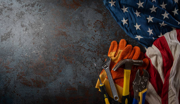 istock Happy Labor day concept. American flag with different construction tools on dark stone background, with copy space for text. 1269750914